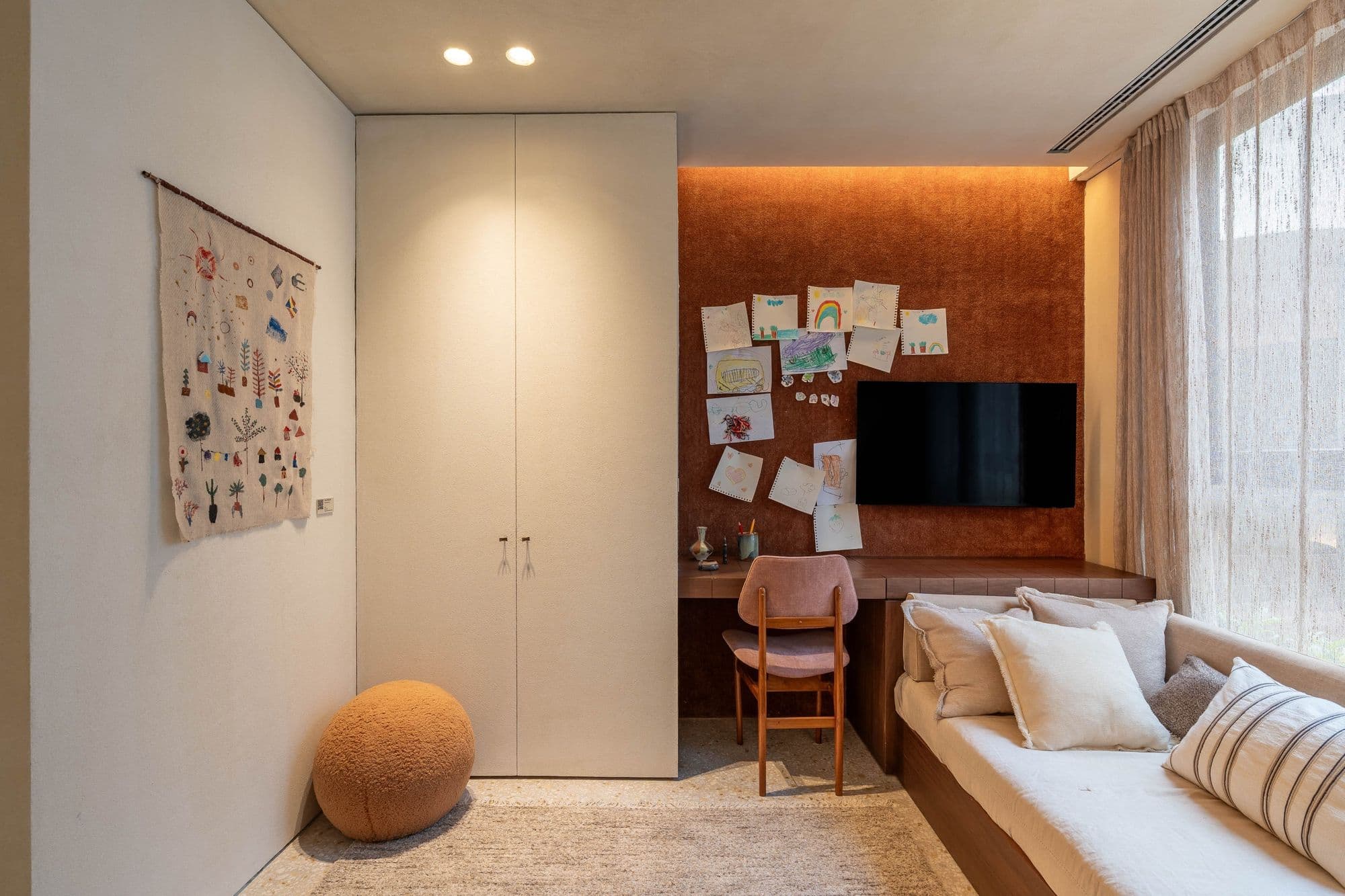 Quarto de hóspedes com armário branco, banco sob a janela e painel de madeira